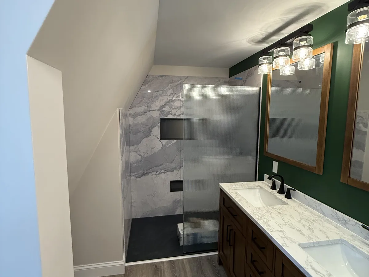 Primary bathroom expansion with walk-in shower and double vanity by Oceanside Carpentry